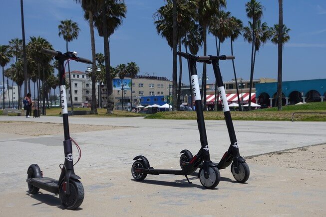 Bird scooters lined up on street ready for rent in California 