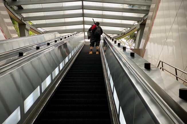 Man rides escalator up from Pershing Square Station Metro in downtown Los Angles
