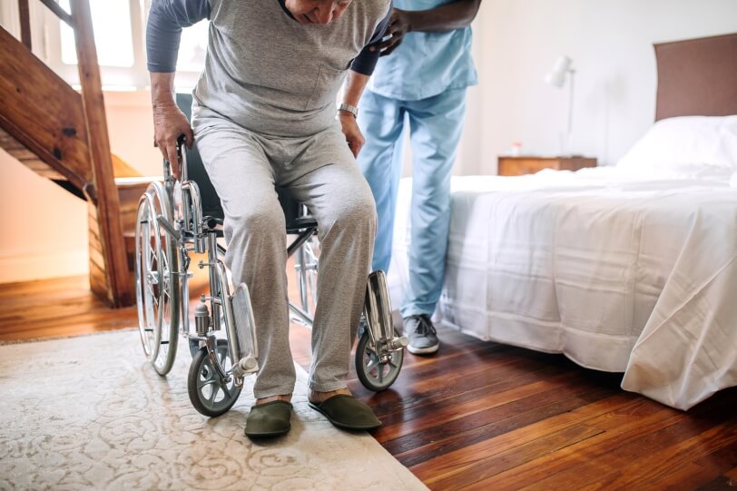 Nurse assists man with spinal injury