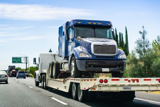 Truck towing another truck on California highway