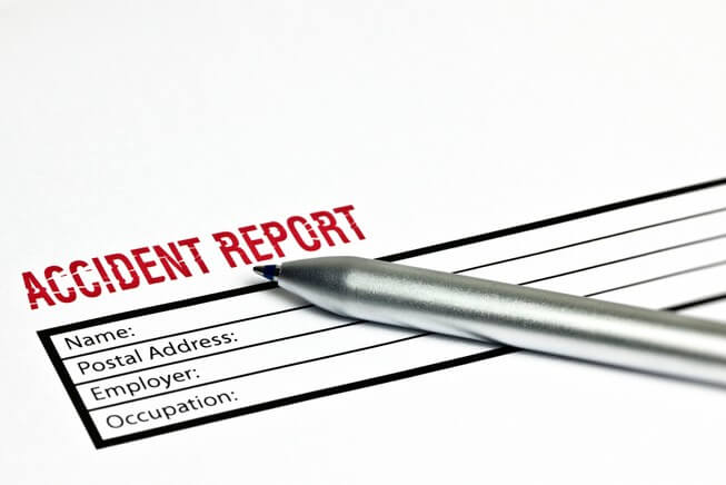 Blank accident report form on table with pen 