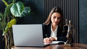 A truck accident lawyer reviewing documents at her desk. Do I need a lawyer for a truck accident claim?