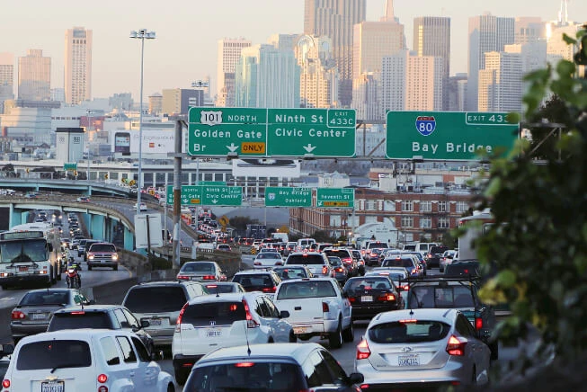 Distracted driver applies makeup while driving in California traffic jam
