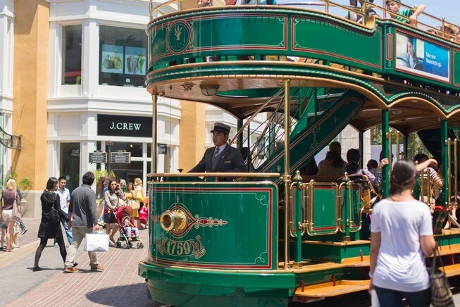 Busy street trolly carrying passengers in The Groove Shopping Center in Los Angeles