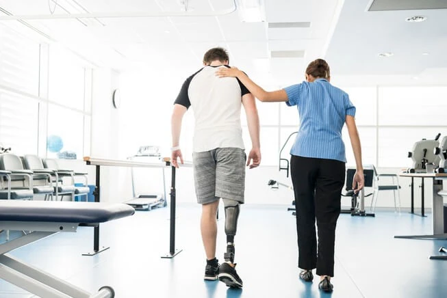 Nurse assists man with leg amputation 